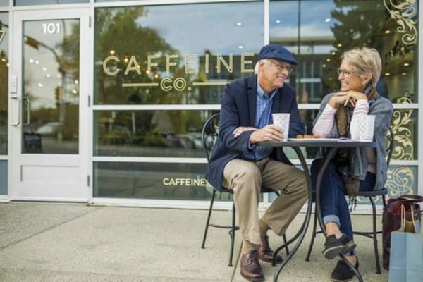 Two older adults having coffee
